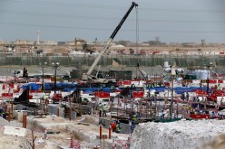 Foreign workers work at one of the football stadiums for the 2022 World Cup in Qatar. 