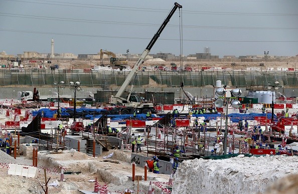 Foreign workers work at one of the football stadiums for the 2022 World Cup in Qatar. 