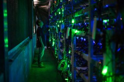 A Bitcoin site manager checks the equipment in a Bitcoin mine in Sichuan.