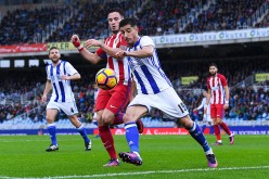 Real Sociedad defender Yuri Berchiche (R) competes for the ball against Atletico Madrid's Saul Niguez.