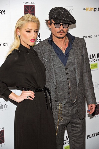 Actors Amber Heard (L) and Johnny Depp attend the 'The Rum Diary' New York premiere at the Museum of Modern Art on October 25, 2011 in New York City. 