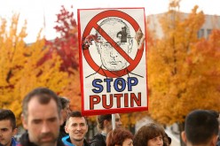 Russian President Vladimir Putin criticised by protestors for military operations in Syria.