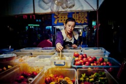 Women empowerment: Millions of women in China became entrepreneurs, thanks to loans granted by the government through local banks. (Above) A fruit stall owner checks on her merchandise.