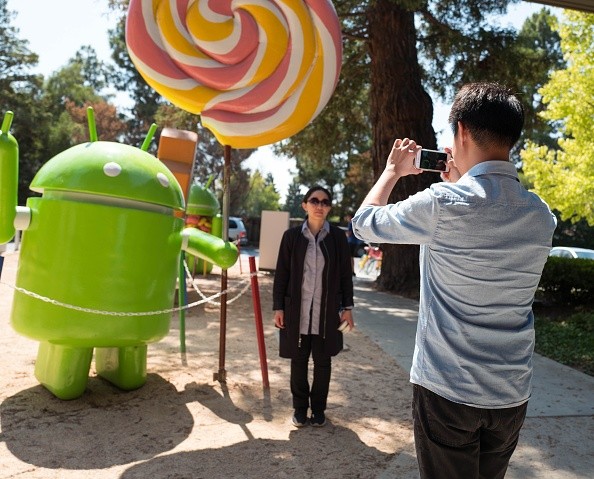 Tourists take photos in front of Google at the Silicon Valley town of Mountain View, California.
