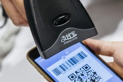 An Alipay user pays through a bar code scanned from his mobile phone. 