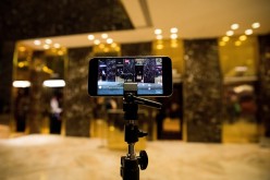 An iPhone streams a Facebook Live feed of the lobby of Trump Tower, Nov. 29, 2016, in New York City.