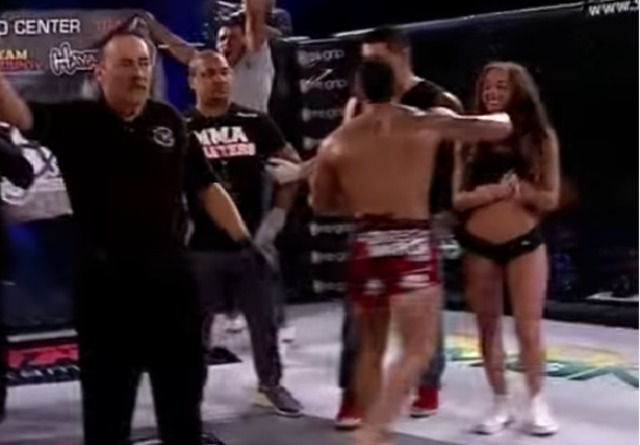 Titan FC's Andrew Whitney unintentionally punches ring girl after learning of title loss.