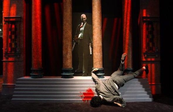 A life-size grisly murder scene draws attention to the exhibit of the violent video game, 'Hitman 2 Silent Assassin', on the first day of E3, the Electronic Entertainment Expo, May 22, 2002 at the Los Angeles Convention Center in Los Angeles, CA .