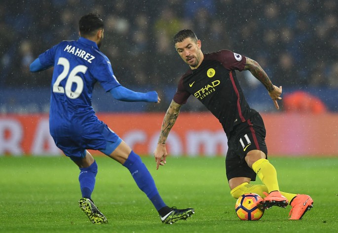 Manchester City defender Aleksandar Kolarov (R) goes against Leicester City's Riyad Mahrez.