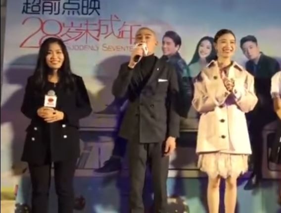 Director Zhang Mo with the cast of "Suddenly Seventeen" at the roadshow in Beijing.