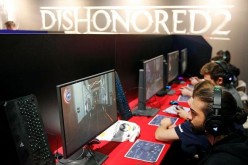 Gamers play the video game 'Dishonored 2' developed by Arkane Studios and published by Bethesda Softworks during the 'Paris Games Week' on October 28, 2016 in Paris, France.
