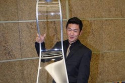 Singapore comedian and actor Adrian Pang lifts a model of the Asian Television Awards trophy after the 2006 gala event at the Suntec Singapore International Convention & Exhibition Centre on November 30, 2006 in Singapore.  