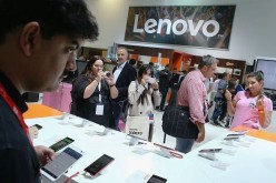 Visitors look at smartphones at the Lenovo stand at the 2015 IFA consumer electronics and appliances trade fair on Sept. 4, 2015 in Berlin, Germany.