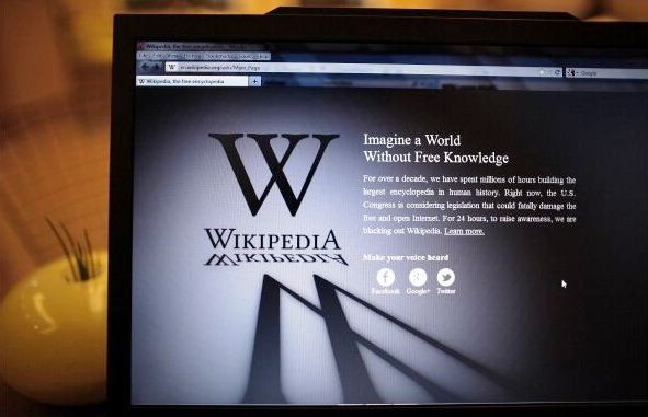 A laptop computer displays Wikipedia's front page showing a darkened logo on Jan. 18, 2012 in London, England. 