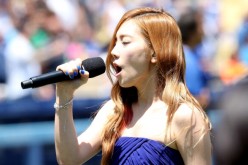 Taeyeon of sings the Korean national anthen during Korea Day ceremonies before the game between the Cincinnati Reds and the Los Angeles Dodgers at Dodger Stadium on July 28, 2013 in Los Angeles, California.