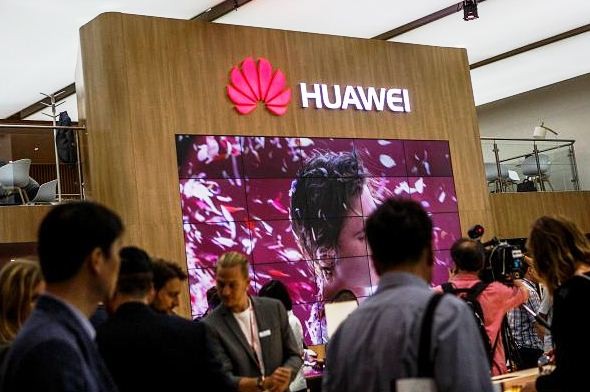 Visitors passing the stand of Huawei at the 2016 IFA consumer electronics trade fair on Sept. 2, 2016 in Berlin, Germany. 