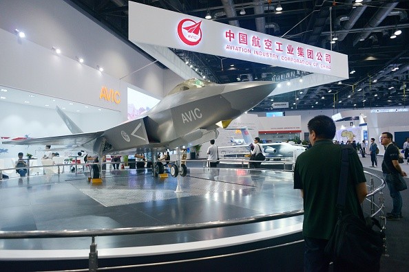 A man looks at a J-31 gyrfalcon stealth fighter plane model designed by Aviation Industry Corporation of China (AVIC) at the Beijing International Aviation Expo in Beijing.
