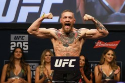 Conor McGregor poses during the weigh-ins for UFC 205.