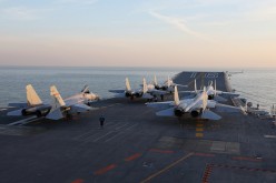 This picture taken on an undisclosed date in December 2016 shows Chinese J-15 fighter jets waiting on the deck of the Liaoning aircraft carrier during military drills in the Bohai Sea, off China's northeast coast.