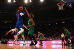 Carmelo Anthony (L) attempts a shot against Marcus Smart (R) during the Knicks vs. Celtics game