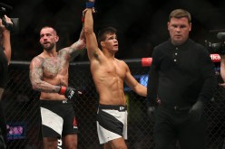 CM Punk raises Mickey Gall's hand after he was beaten in their UFC 203 encounter.