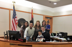 Michael Brown poses for a photo with his new family and the judge that finalised his adoption last Dec. 20.