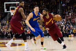 Tristan Thompson sets a pick as Kyrie Irving of the Cleveland Cavaliers drives around Klay Thompson of the Golden State Warriors during the second half at Quicken Loans Arena on December 25, 2016.