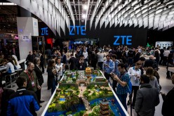 Attendees visit the stand of ZTE during the second day of the Mobile World Congress 2016.