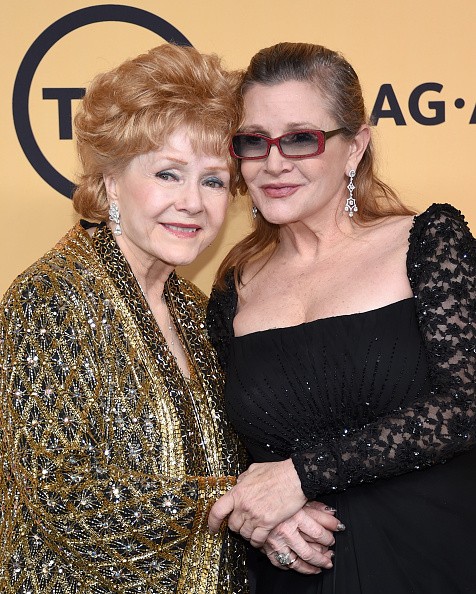 Actresses Debbie Reynolds (L), recipient of the Screen Actors Guild Life Achievement Award, and Carrie Fisher pose in the press room at the 21st Annual Screen Actors Guild Awards at The Shrine Auditorium on January 25, 2015 in Los Angeles, California. 