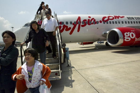 Travellers are seen disembarking from the Air Asia Boeing 737-300 flight from Bangkok to Phuket on February 25, 2004 in Phuket, Thailand. 