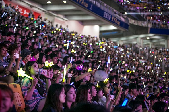 South Korean K-Pop fans, mostly of a boy band called Exo, cheer as a K-Pop band perform on stage on June 18, 2016 in South Korea. The government try to boost tourism by sponsoring and directly organizing K-Pop concerts in big venues.   