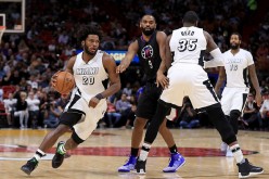 Justise Winslow of the Miami Heat drives around Wesley Johnson of the LA Clippers during a game at American Airlines Arena on December 16, 2016 in Miami, Florida.