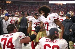 Colin Kaepernick of the San Francisco 49ers and tackle Joe Staley high five on the bench after a Kapernick's fourth quarter touchdown during NFL football game against the Arizona Cardinals at University of Phoenix Stadium on November 13, 2016 in Glendale,