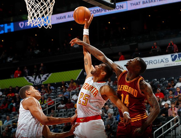 Thabo Sefolosha of the Atlanta Hawks battles for a rebound against DeAndre Liggins of the Cleveland Cavaliers at Philips Arena on October 10, 2016 in Atlanta, Georgia. 