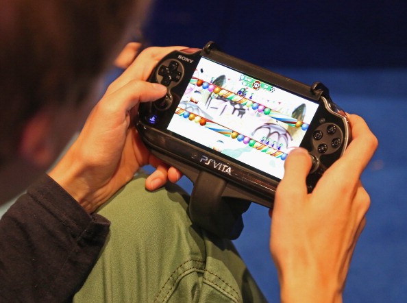 A gaming enthusiast tries out a Sony Playstation Vita game at the Gamescom 2013 gaming trade air on August 22, 2013 in Cologne, Germany.