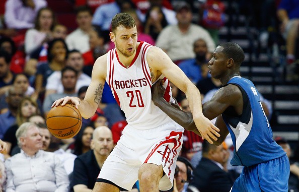 Donatas Motiejunas of the Houston Rockets drives with the basketball against Gorgui Dieng of the Minnesota Timberwolves during their game at the Toyota Center on March 18, 2016 in Houston, Texas. 