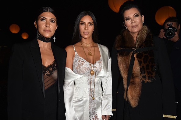 Kim Kardashian (C) with her mom Kris Jenner (R) and her sister Courtney Kardashian (L) at Paris Fashion Week last Oct. 2, 2016.