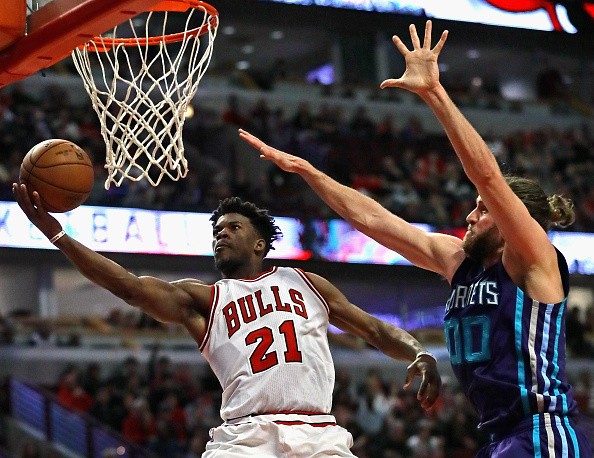 Jimmy Butler of the Chicago Bulls puts up a shot past Spencer Hawes of the Charlotte Hornets on his way to a game-high 52 points at the United Center on January 2, 2017 in Chicago, Illinois. The Bulls defeated the Hornets 118-111.