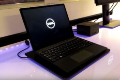 The Dell Latitude 7285 is put on display while showcasing most of its features. 