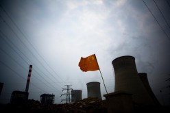 A Chinese flag flies over a coal-fired power plant in China.