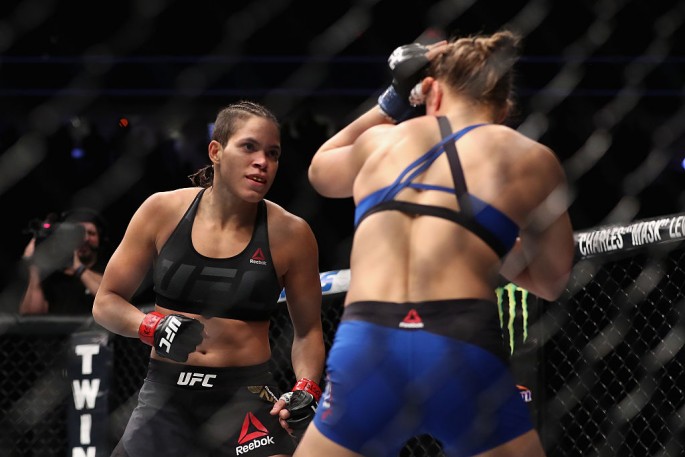 Amanda Nunes of Brazil and Ronda Rousey face off in their UFC women's bantamweight championship bout during the UFC 207 event at T-Mobile Arena on December 30, 2016 in Las Vegas, Nevada. 