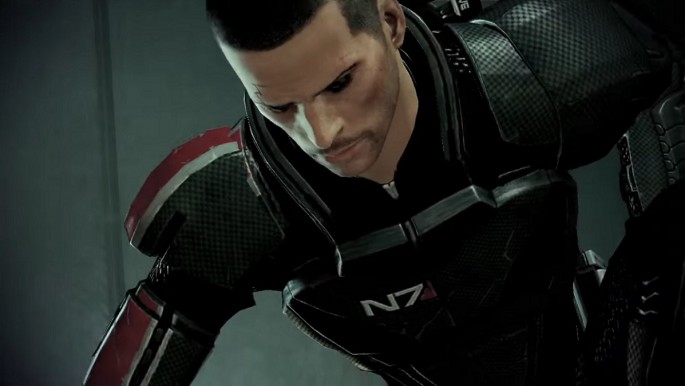 Commander Shepard kneeling down in defeat in 'Mass Effect 2.'