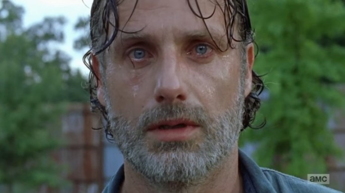 Rick sheds tears as he watches Negan and his group move out of Alexandria in "The Walking Dead" midseason finale. 