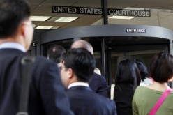 People line up to enter the Robert F. Peckham United States Courthouse Building where Apple's patent infringement case is heard.