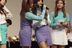 TWICE members, including Tzuyu, on stage during the fan meeting. 