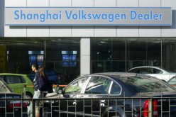A couple walk through a Volkswagen auto dealership in Beijing.