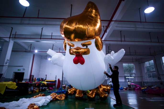A worker inflates a giant chicken resembling Donald Trump in a factory in Jiaxing, Zhejiang Province, on Jan. 6, 2017.