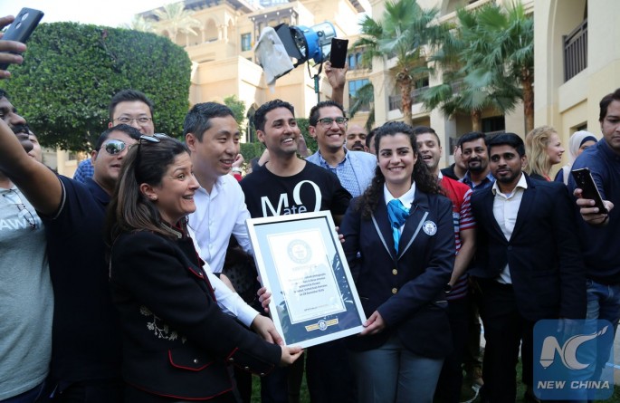 Huawei employees pose with Guinness World Record officials after breaking the record for most selfies at Dubai, U.A.E., on Jan. 10, 2017.