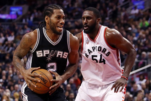 Kawhi Leonard of the San Antonio Spurs battles with Patrick Patterson of the Toronto Raptors during an NBA game at the Air Canada Centre on December 09, 2015 in Toronto, Ontario, Canada.