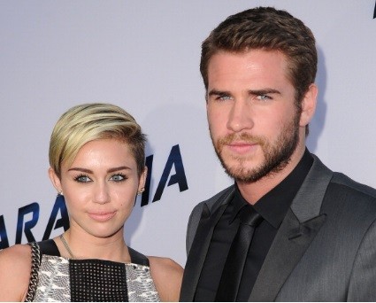 MIley Cyrus and Liam Hemsworth arrive at the 'Paranoia' - Los Angeles Premiere at DGA Theater on August 8, 2013 in Los Angeles, California. 